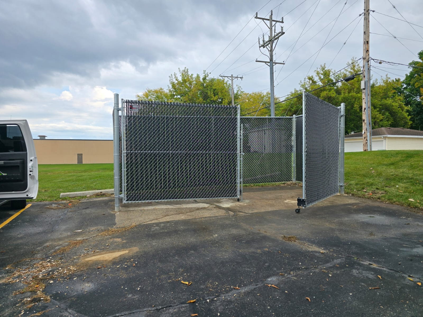 Commercial silver chain-link enclosure with rolling gate