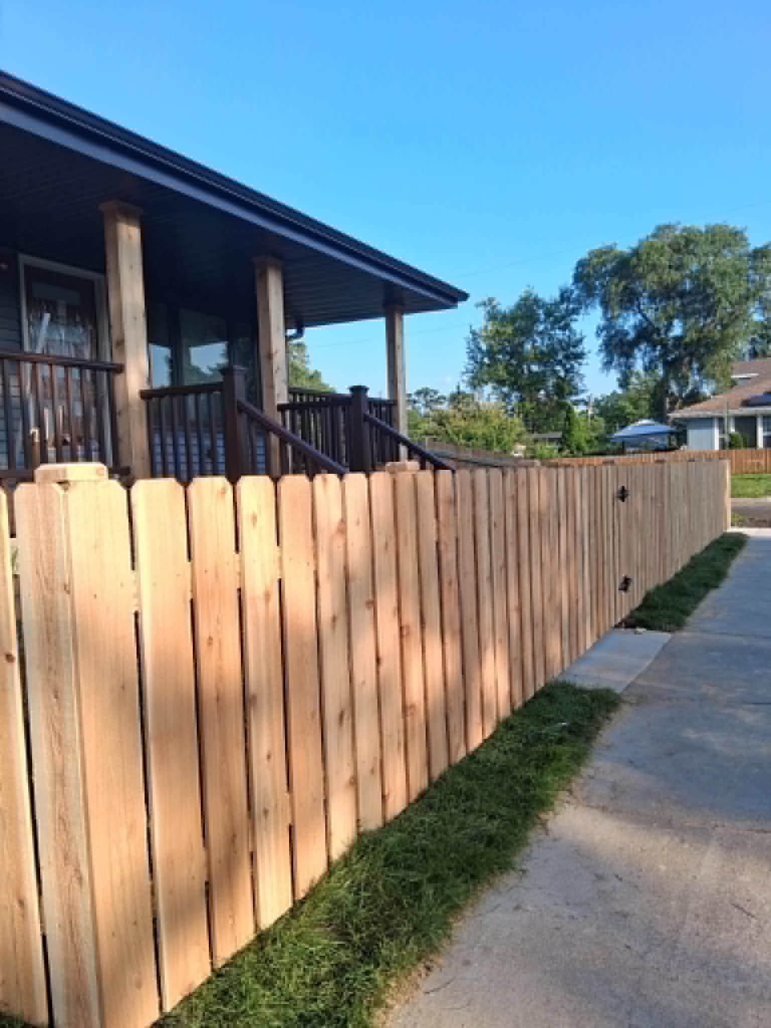 New wooden fence installed along a residential side yard
