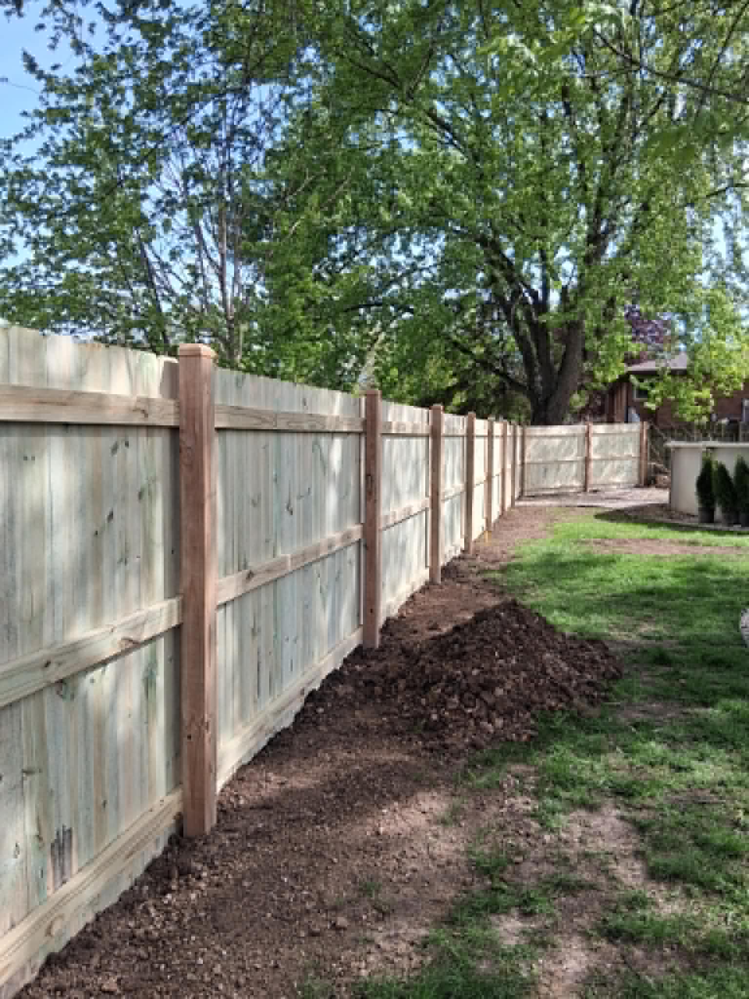 Wood privacy fence installed around a residential backyard